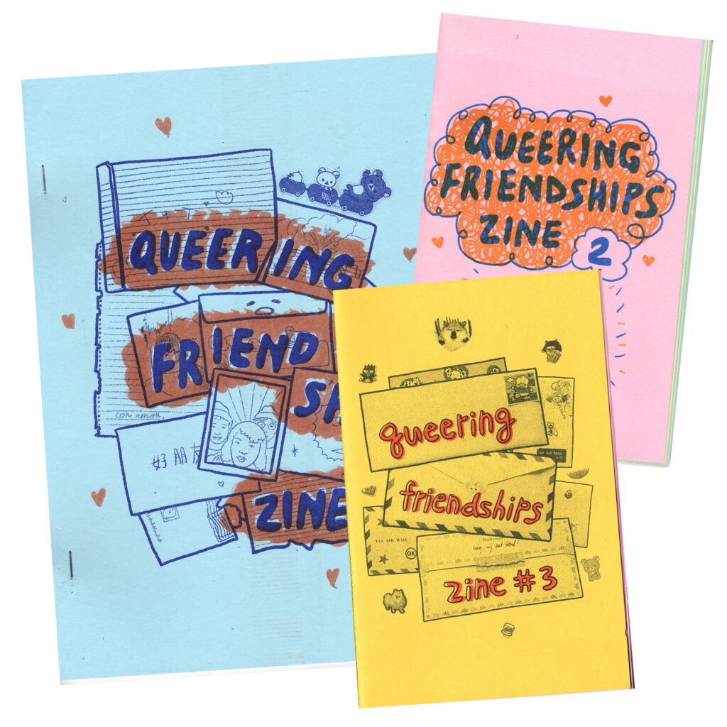 The covers of queering friendships zine 1 through 3 are staggered on top of one another. The third issue is on bright yellow paper with dark blue background and red words. The second issue is on baby pink paper, and the background drawing is orange while the title is drawn in dark blue. The first issue is larger than the other two, and is on light blue paper, with background bubbles in orange ink, and the title is blue. All 3 zine covers show artwork of mail and letters from friends.